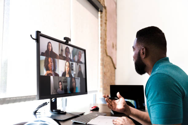 istock Businessman participates in virtual staff meeting 1255371694