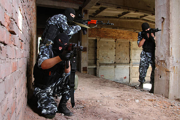 istock Soldiers in black masks targeting with guns 125537197