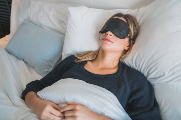 istock Woman sleeping with sleep mask. 1255373073