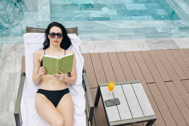 istock Young woman concentrated on reading 1255373447