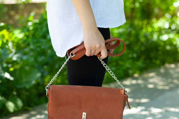 istock woman hand bag 1255373926