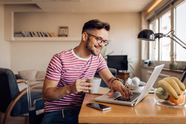 istock Happy young businessman freelancing from home 1255376481