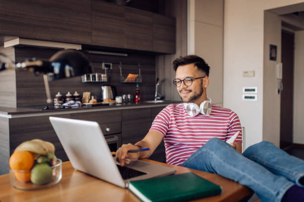 istock Young freelancer working online from his home office 1255376683