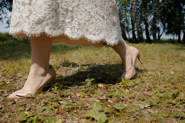 istock a girl walks through the forest in heels 1255378814