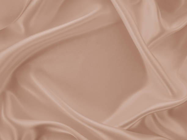 istock Beautiful elegant wavy beige or light brown satin silk. 1255379446