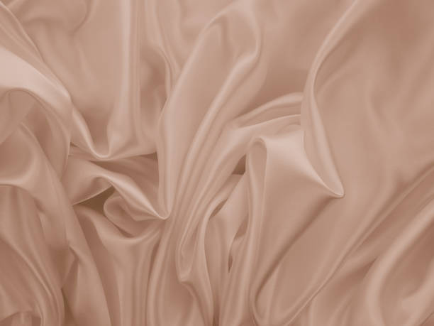 istock Beautiful elegant wavy beige or light brown satin silk. 1255379458