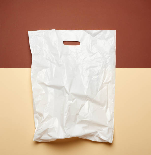istock white plastic bag on a brown background, flat lay. Plastic rejection concept 1255381922