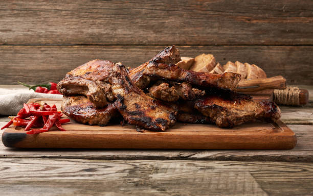 istock grilled pork steaks on the bone on a kitchen cutting board and red chili pepper 1255382486