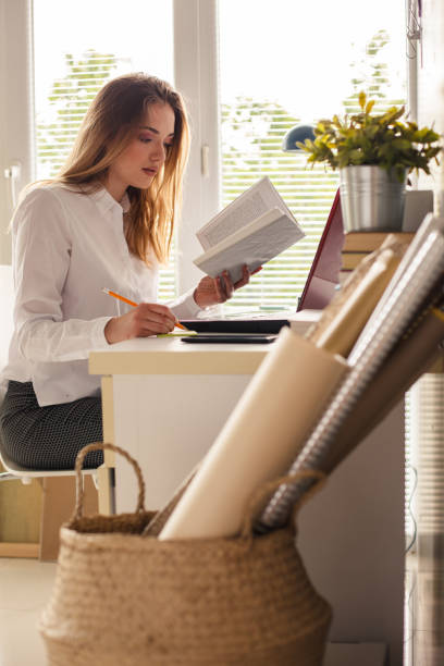 istock Focused young woman studying for a test at her desk 1255382571