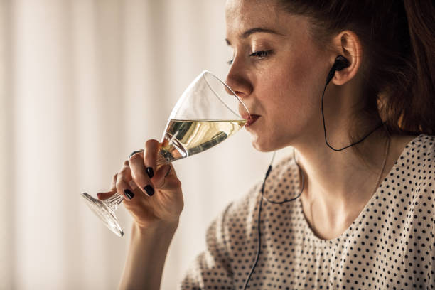 istock Taking a sip of white wine 1255383447
