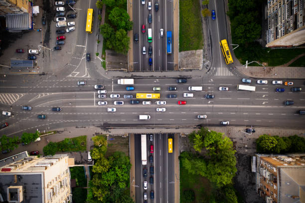istock Road traffic with traffic jam on a highway overpass, top view. Two-level intersection of perpendicular highways with traffic on the bridge. 1255384989
