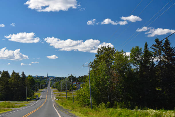 istock rural road under the summer sun in Quebec, Canada 1255386242