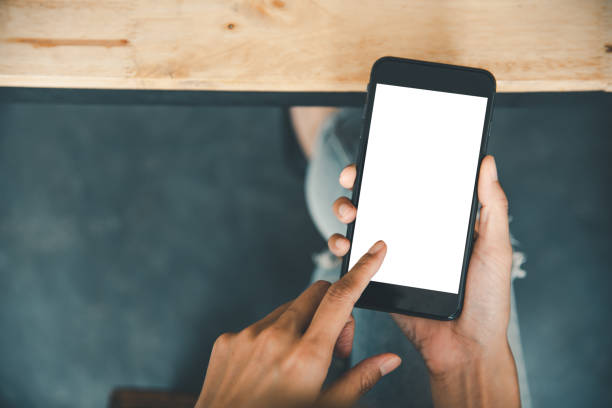 istock Asian business woman  hand using and touching smart phone with white blank empty screen. 1255387682