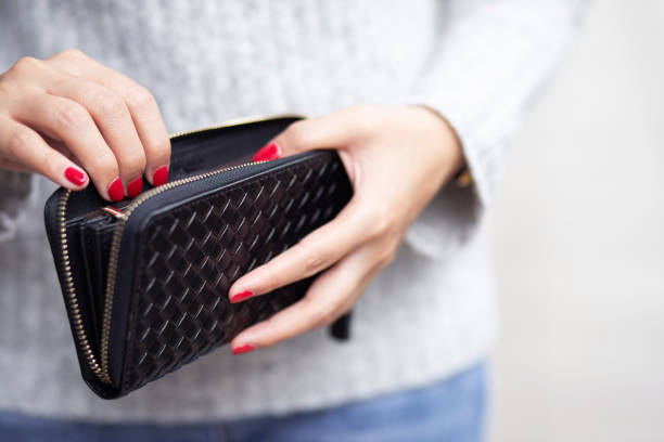 woman is carrying wallet,she is paying for the product. at the mall - wallet buying white dollar imagens e fotografias de stock