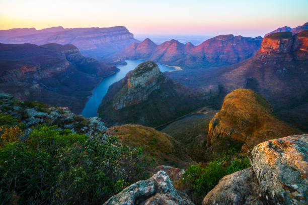 three rondavels and blyde river canyon at sunset, south africa 103 view of three rondavels and the blyde river canyon at sunset in south africa blyde river canyon stock pictures, royalty-free photos & images