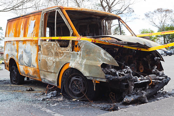 istock Burnt down van on street with trespassing cordon tape 125539104