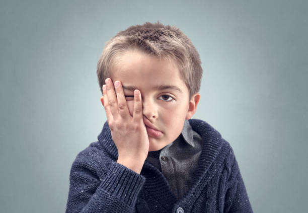 istock Boy feeling fed up, depressed, bored or stressed and showing despair 1255391075