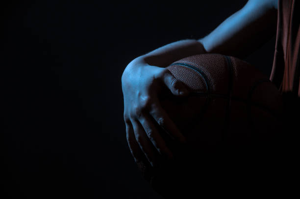 istock Cropped Hand Holding Basketball 1255391501