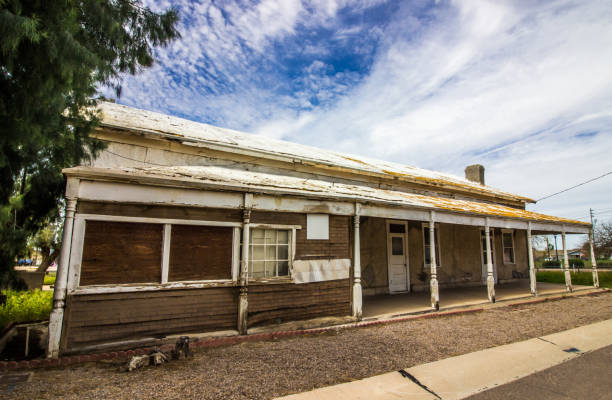 istock Old Boarded Up Building With Porch Overhang 1255393664
