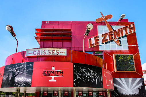 Paris, France - June 22, 2020: Low angle view of the sign and logo of Le Zenith concert hall on the facade of its ticket office, housed beside the arena in a folly of the Parc de la Villette.