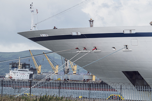 Belfast, Northern Ireland, United Kingdom - July 5, 2020: The profile of the bow of a small cruise ship (1,400 passengers and crew), the MV Viking Sky, operated by Viking Cruises.  It is moored at the shipyards of Harland and Wolff for a refit.  Built in 2017, the ship experienced engine failure in March 2019 off the coast of Norway during a storm, necessitating a MayDay call and the airlift of passengers.