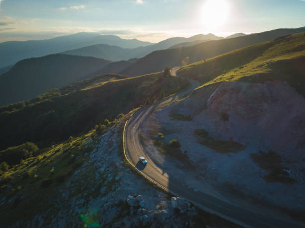 istock driving on forest road in the mountains at sunset 1255396547