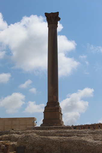 Pompey`s Pillar or Serapeum pillar is the name given to a Roman triumphal column in Alexandria, Egypt. Set up in honour of the augustus Diocletian between 298-302 AD, the giant Corinthian column originally supported a colossal porphyry statue of the emperor in armour. It stands at the eastern side of the temenos of the Serapeum of Alexandria, beside the ruins of the temple of Serapis itself. The erroneous name and association with Pompey stems from historical misreading of the Greek dedicatory inscription on the base