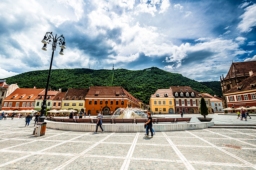 Brasov, Romania - 23 June, 2020: color image depicting the ancient cobbled streets of Brasov, a city in the Transylvania region of Romania. Romania has just opened up after the Covid-19 lockdown, and people are beginning to enjoy the terraces, bars, restaurants and shops of this charming city once again.