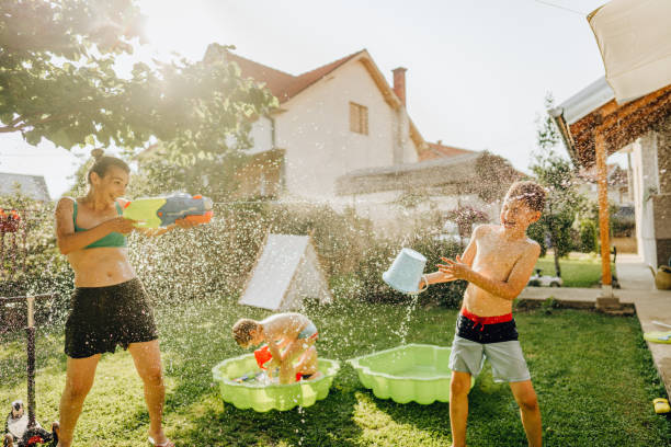 istock Water fight with our mommy 1255398469