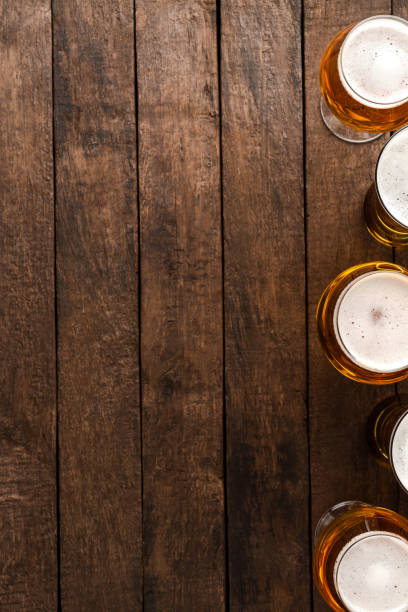 istock Beer glasses on wooden table with copyspace. 1255400628