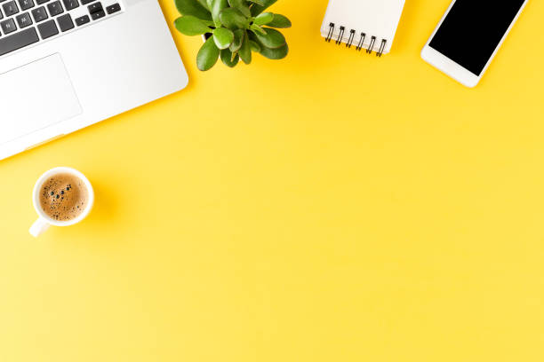 istock Business background with laptop and accessories. Office desktop 1255401373
