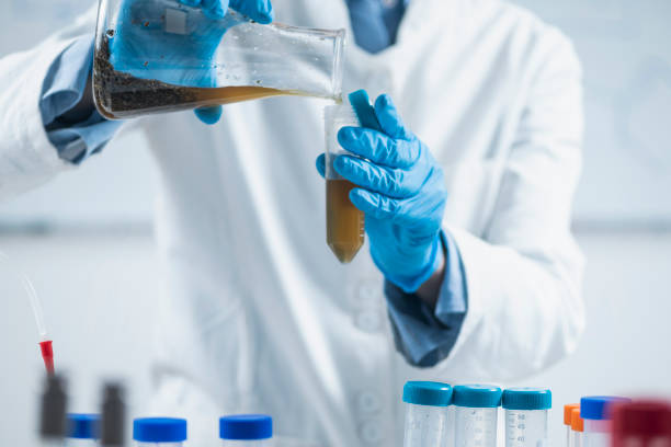 istock Organic Food Science Inspector Examining Laboratory Flask with Plant Sample Dissolved in Water 1255401401