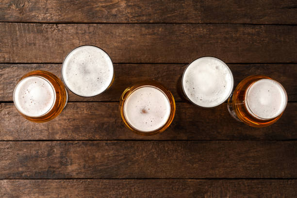 istock Beer glasses on wooden table with copyspace. 1255401819