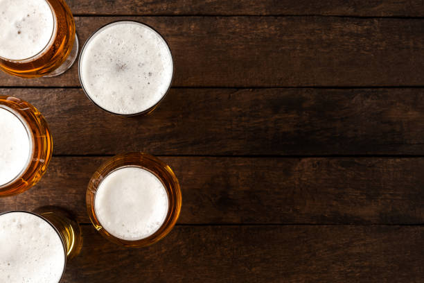 istock Beer glasses on wooden table. 1255401952