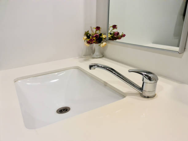 istock Modern white bathroom sink with faucet 1255402959