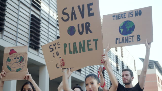 Slow motion video of a group of people participating in a protest against global warming