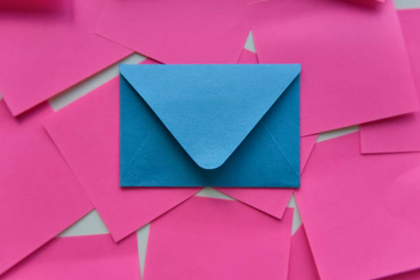 istock selective focus, single blue envelope in the middle of pink stickers 1255407730