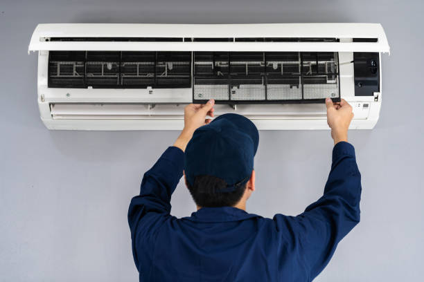 istock technician service removing air filter of air conditioner for cleaning 1255408057