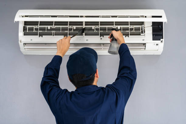 istock technician service cleaning the air conditioner 1255408063