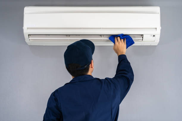 istock technician service cleaning air conditioner with cloth 1255408072