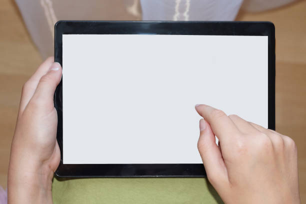 istock tablet with white screen in female hands, mock up. 1255408902