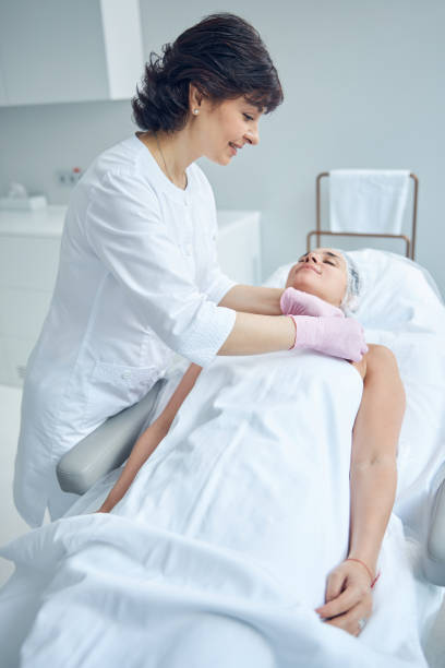 istock Positive beautician preparing the client for skincare treatment 1255410194
