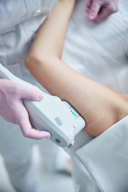 istock Female body treatment with high technology tool 1255410195