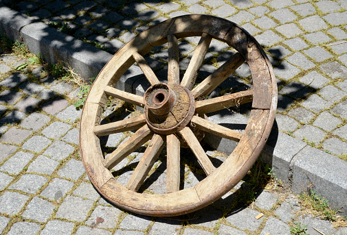 old wooden wheel in street