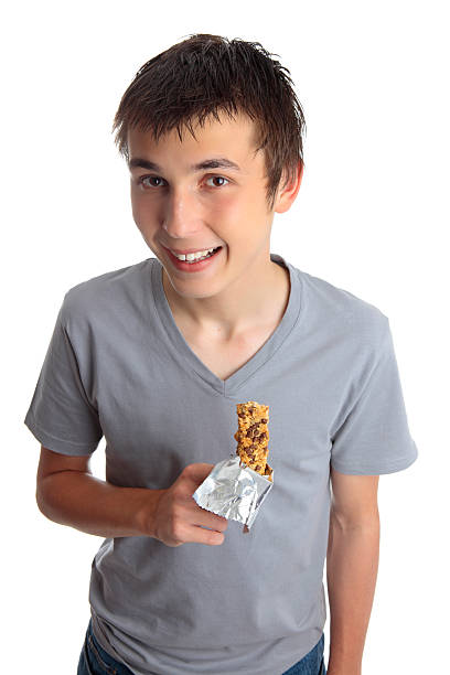 istock Smiling boy holding muesli bar 125541237