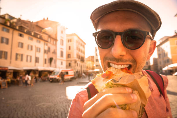 istock Men eating Pizza - Tourist in Italy 1255412838