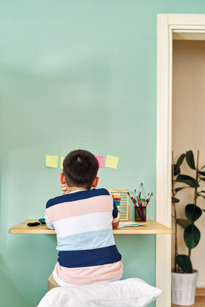 istock Education at home. Cute child learning mathematics at home. Homeschooling 1255413236