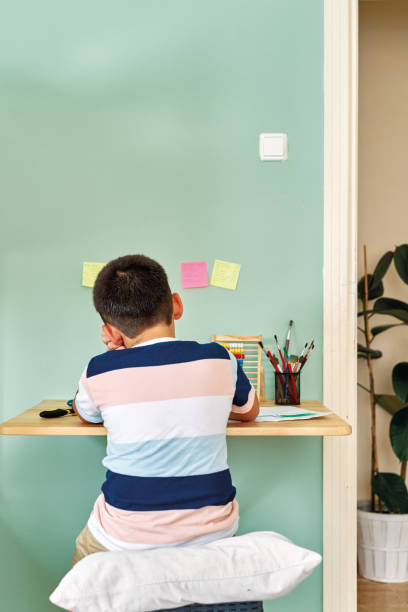 istock Education at home. Cute child learning mathematics at home. Homeschooling 1255414476