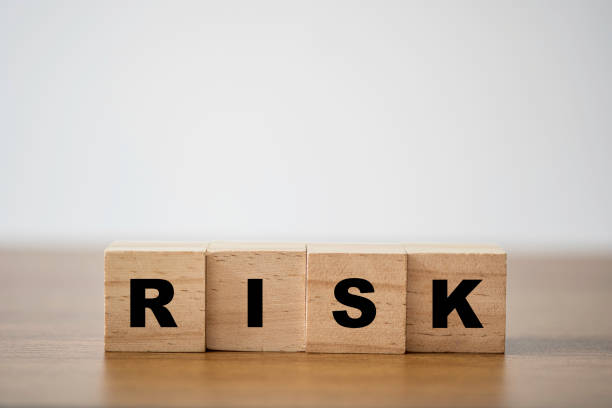 istock Stacking of wooden which print screen risk wording on the table with copy space. risk management concept. 1255414758