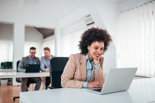istock Attractive cheerful woman working in office. 1255415794